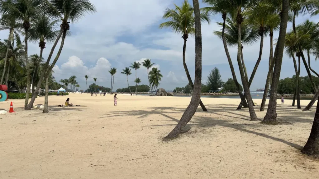 Sentosa Island cable car over turquoise water with Universal Studios Singapore and sandy beaches